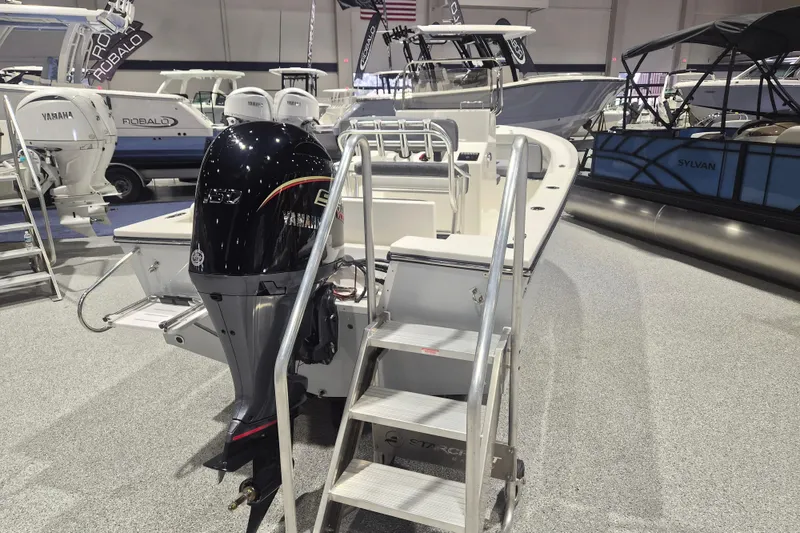 Slide: The Image of 2026 Defiance 205 Catalina boat with Yamaha engine displayed at a boat show. - 2