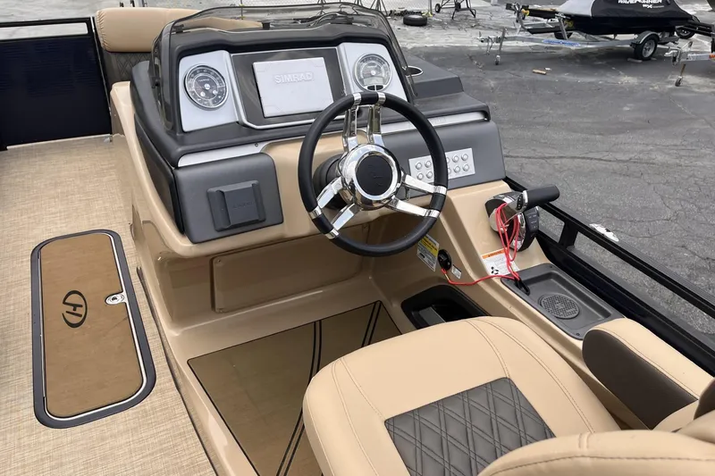 Slide: The Image of 2022 Harris Solstice 230 CWDH boat dashboard with steering wheel and control panel. - 4