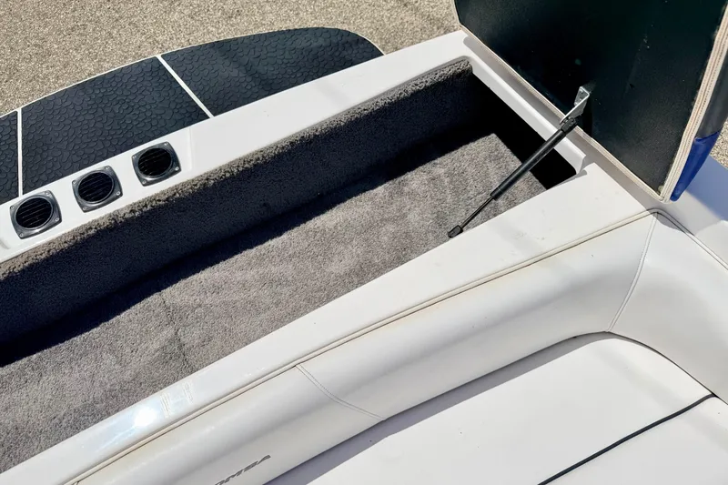 Slide: The Image of 2008 Moomba Outback V boat interior storage compartment with open lid and carpeted lining. - 22