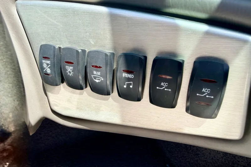 Slide: The Image of Dashboard switches of a 2008 Moomba Outback V boat, including navigation and stereo controls. - 43