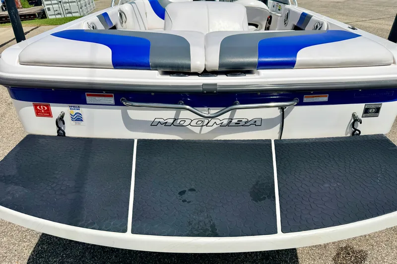 Slide: The Image of 2008 Moomba Outback V boat with blue and gray seating, rear view. - 13