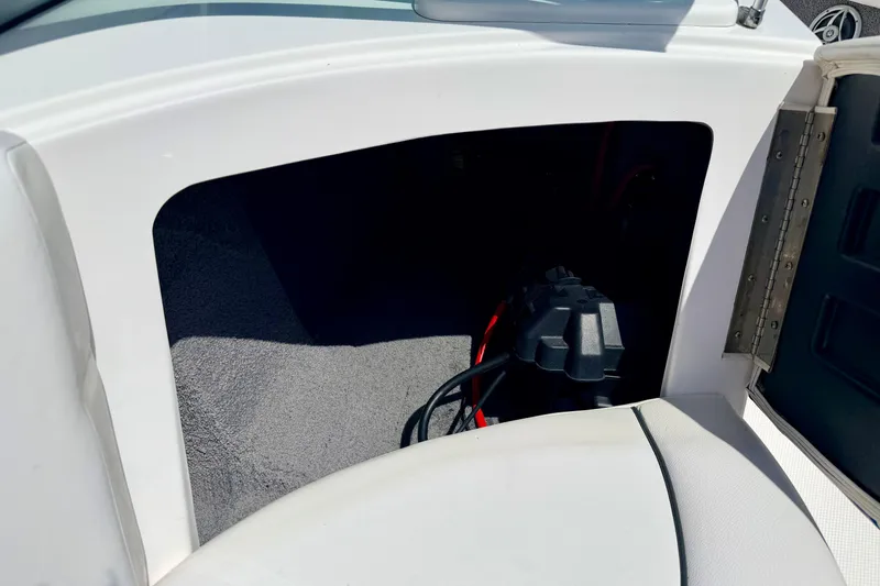 Slide: The Image of 2008 Moomba Outback V storage compartment with visible wiring and carpeted interior. - 33