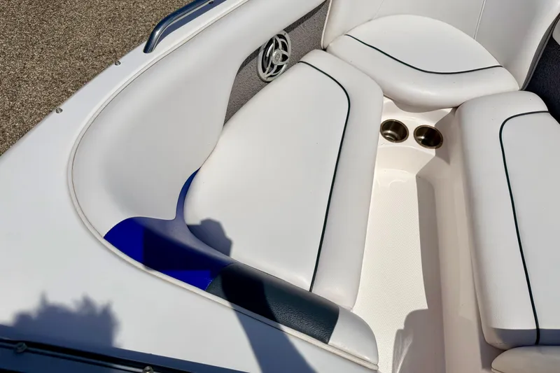 Slide: The Image of Interior seating of a 2008 Moomba Outback V boat with white upholstery and cup holders. - 50