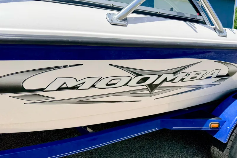 Slide: The Image of 2008 Moomba Outback V boat with bold logo and sleek design. - 9