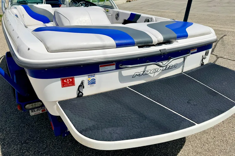 Slide: The Image of 2008 Moomba Outback V boat with blue and gray seating, rear view. - 17