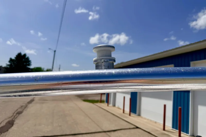 Slide: The Image of Close-up of a 2008 Moomba Outback V boat's metal railing under a clear blue sky. - 61