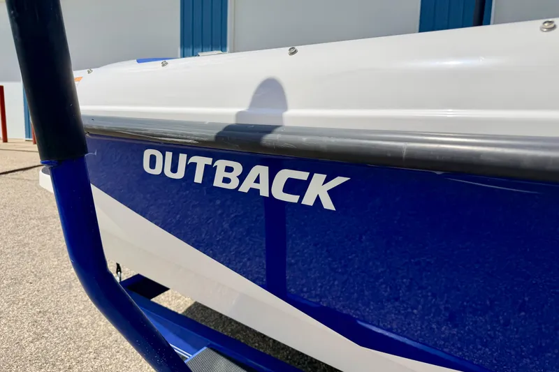Slide: The Image of 2008 Moomba Outback V boat, blue and white exterior, parked outdoors. - 10