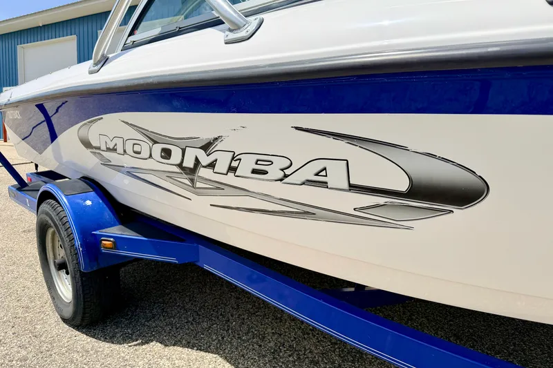 Slide: The Image of 2008 Moomba Outback V boat on trailer, featuring sleek design and bold logo. - 7