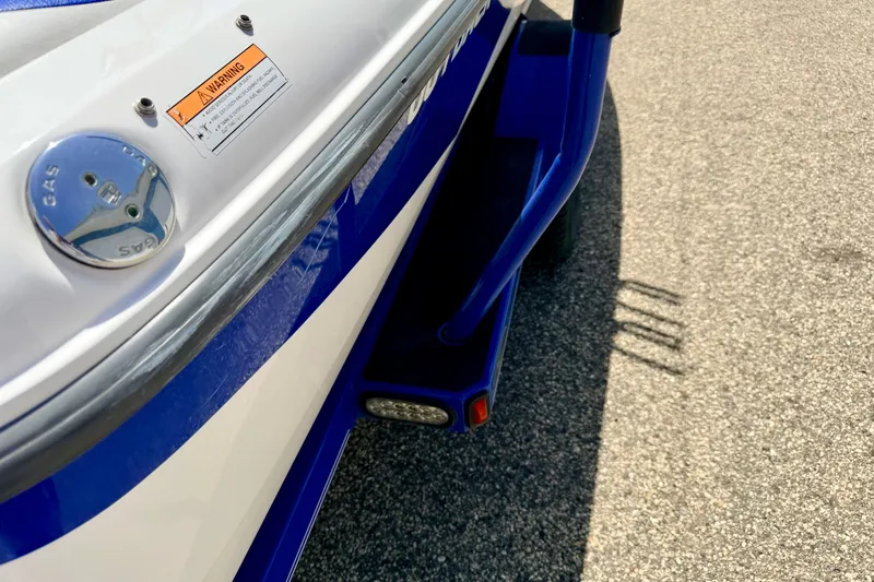 Slide: The Image of 2008 Moomba Outback V boat detail showing gas cap and warning label. - 73