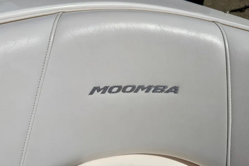 Slide: The Image of Moomba Outback V 2008 boat seat with logo, featuring white upholstery. - 55