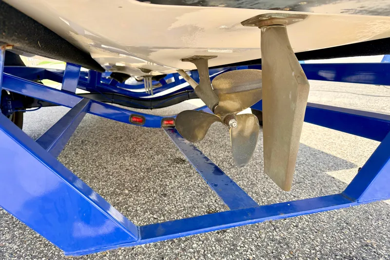 Slide: The Image of 2008 Moomba Outback V boat propeller and rudder on blue trailer. - 15