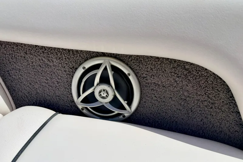 Slide: The Image of Speaker on 2008 Moomba Outback V boat interior, featuring gray carpet and white upholstery. - 57