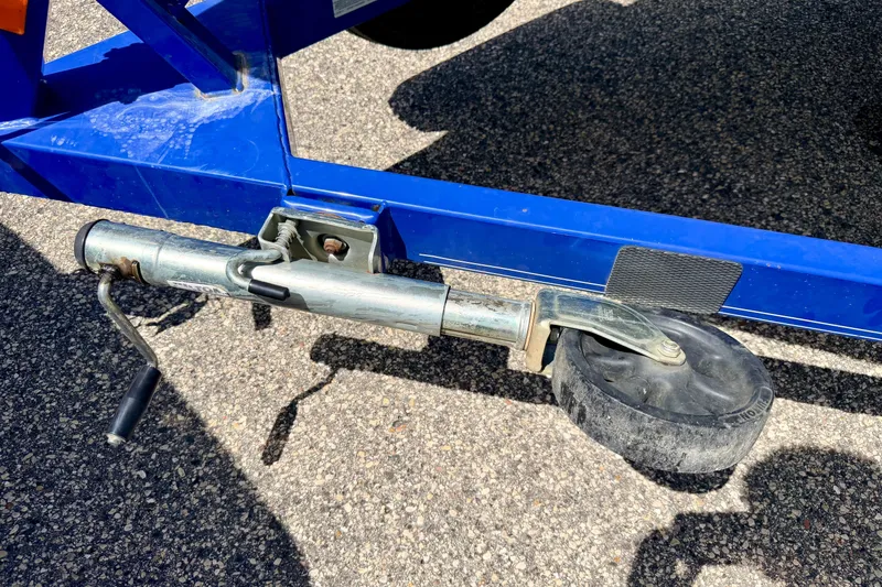 Slide: The Image of Trailer jack wheel on a 2008 Moomba Outback V boat trailer, parked on asphalt. - 66