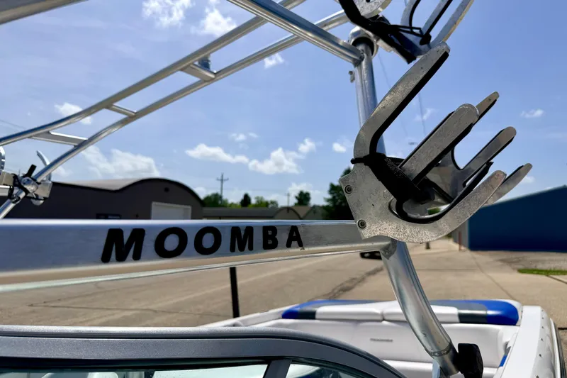 Slide: The Image of 2008 Moomba Outback V boat tower with wakeboard rack under clear blue sky. - 64