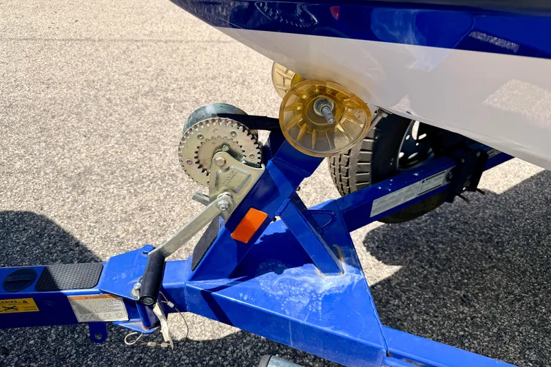 Slide: The Image of 2008 Moomba Outback V boat trailer with winch and roller on asphalt. - 67