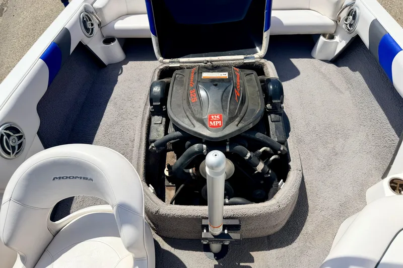 Slide: The Image of 2008 Moomba Outback V boat engine compartment with 325 MPI engine, surrounded by white seating. - 31