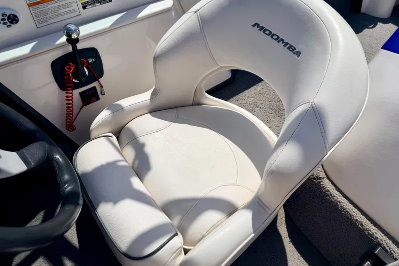 Slide: The Image of 2008 Moomba Outback V boat interior with white captain's chair and control panel. - 36