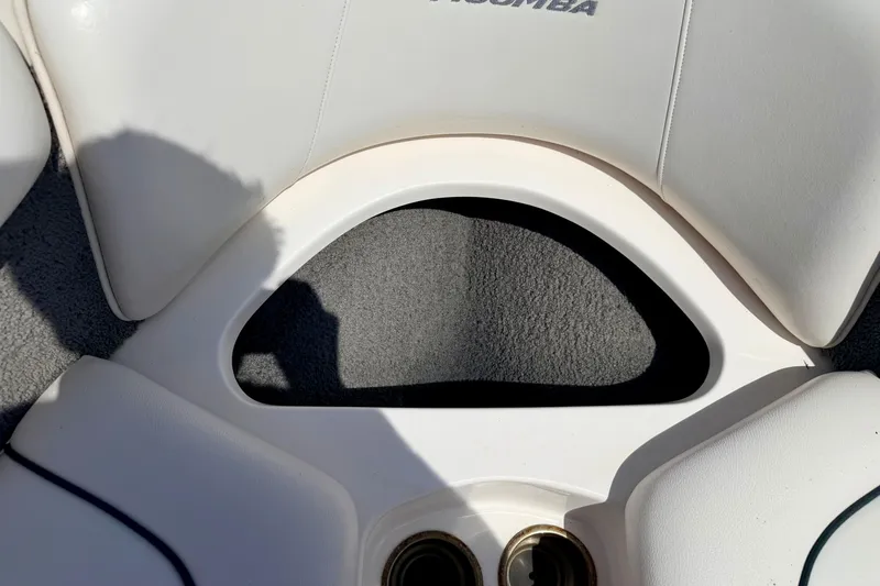 Slide: The Image of 2008 Moomba Outback V boat interior with white cushioned seating and cup holders. - 54