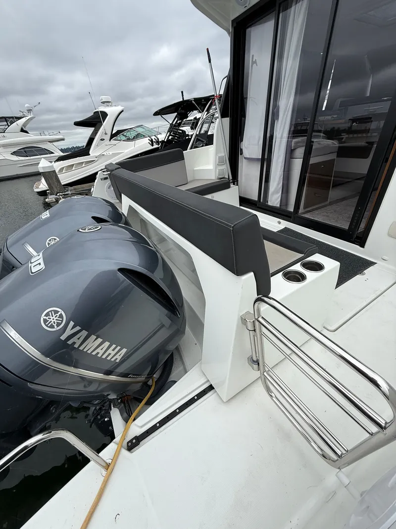 Slide: The Image of The image shows the stern of a Jeanneau NC 1095 boat with two Yamaha outboard engines. - 45