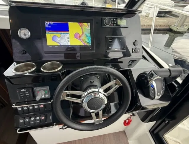 Slide: The Image of The image shows the helm of a 2021 Jeanneau NC 1095 with modern navigation instruments. - 17