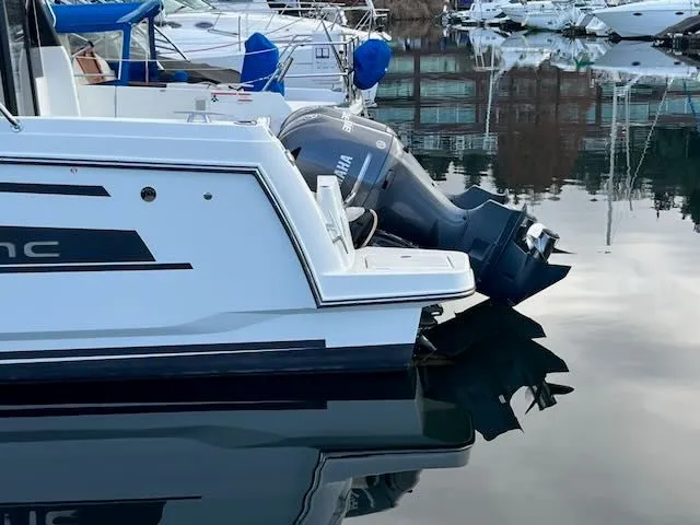 Slide: The Image of A 2021 Jeanneau NC 1095 is on the water, featuring a Yamaha outboard motor. - 2