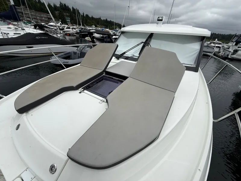 Slide: The Image of The boat features two cushioned sun pads on the deck, docked in a marina. - 41