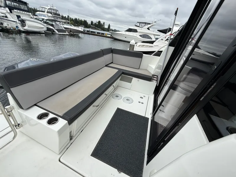 Slide: The Image of The image shows the cockpit of a 2021 Jeanneau NC 1095 with gray upholstery. - 46