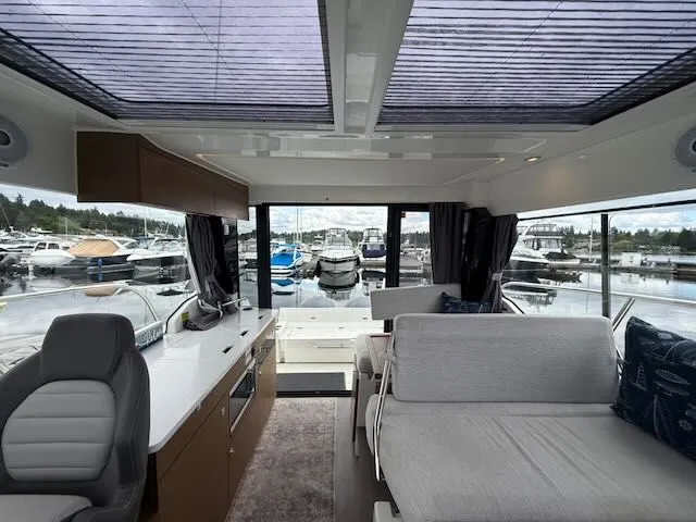 Slide: The Image of Interior of a 2021 Jeanneau NC 1095 with modern design and large windows. - 10