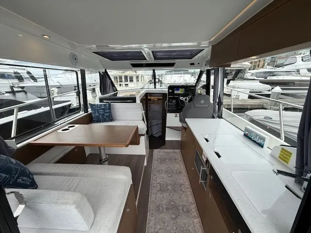 Slide: The Image of Interior of a 2021 Jeanneau NC 1095 with modern kitchen and seating area. - 3