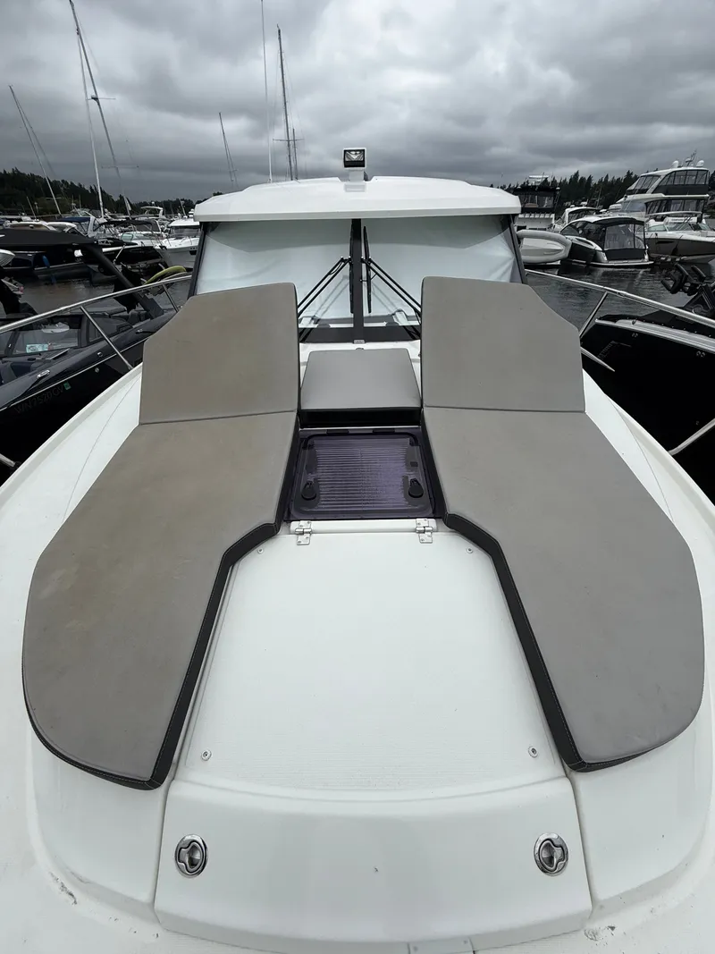 Slide: The Image of The boat features a modern design with cushioned sun pads on the deck. - 43