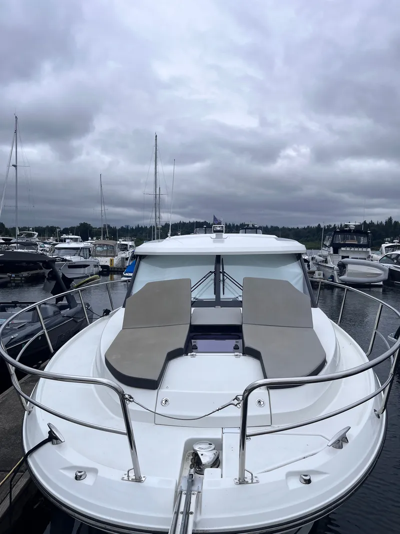 Slide: The Image of A 2021 Jeanneau NC 1095 is docked. It features a spacious foredeck. - 36