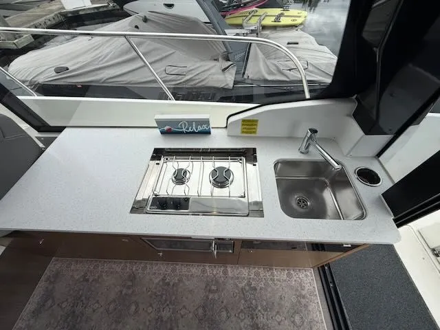 Slide: The Image of The galley on a boat with two burners and a sink. - 14