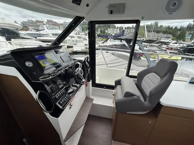 Slide: The Image of Interior view of the Jeanneau NC 1095 with helm and seating. - 16