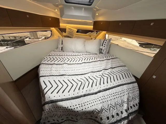 Slide: The Image of The image shows a cozy cabin with a double bed and modern wood accents. - 28