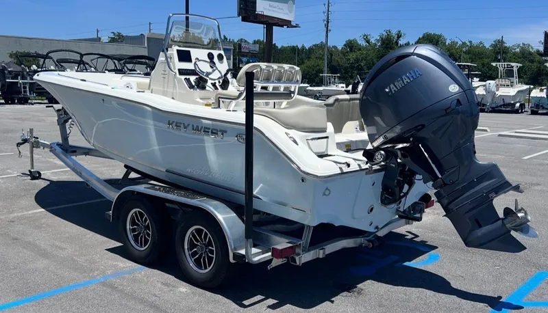 Slide: The Image of A 2026 Key West 203 FS boat on a trailer in a parking lot. - 6