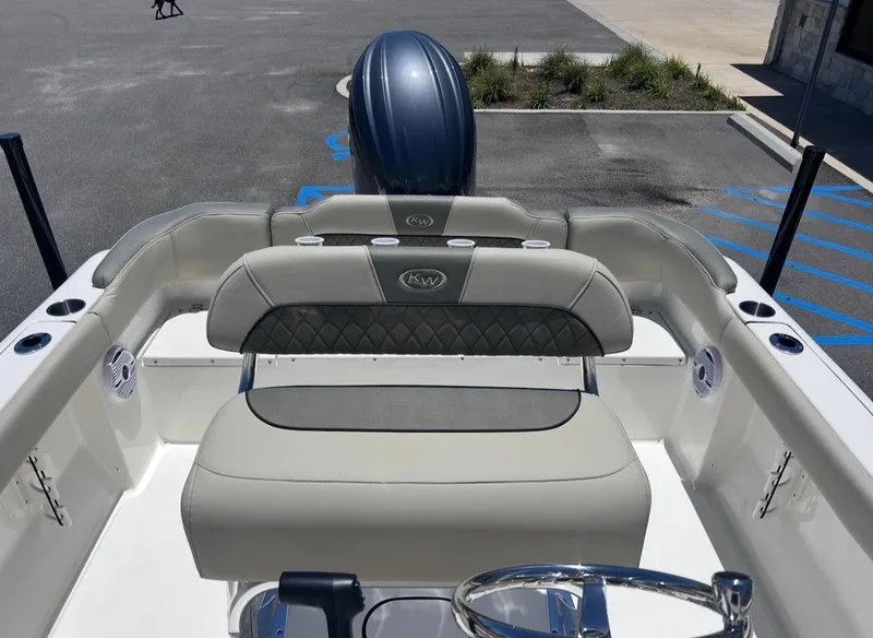 Slide: The Image of The image shows the cockpit of a Key West 203 FS boat with beige seating. - 12