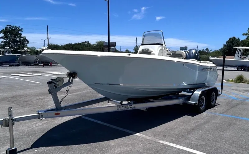 Slide: The Image of A Key West 203 FS boat on a trailer in a parking lot. - 8