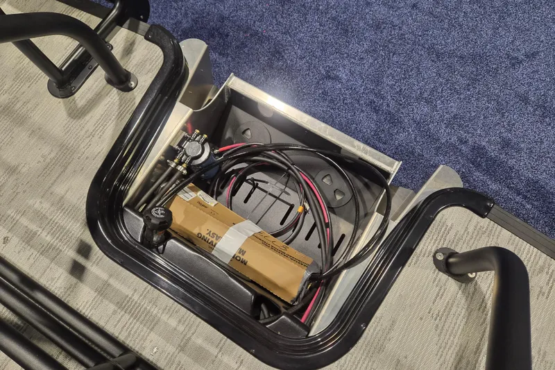 Slide: The Image of Storage compartment of 2026 Sylvan L3 ULZ with cables and a box. - 17