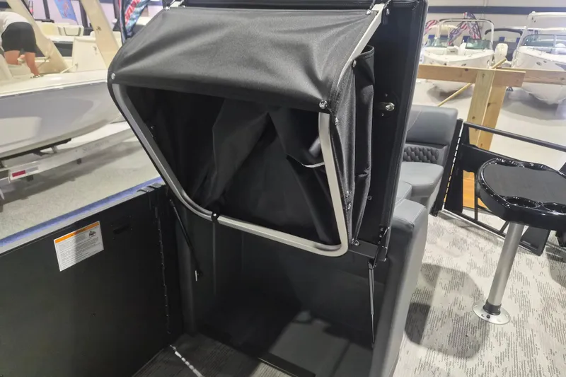 Slide: The Image of 2026 Sylvan L3 ULZ boat interior with foldable storage compartment and seating area. - 20