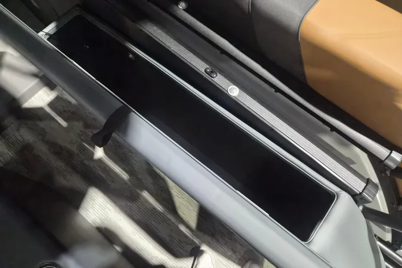 Slide: The Image of Interior storage compartment of 2026 Sylvan L3 ULZ boat, featuring sleek design and ample space. - 13