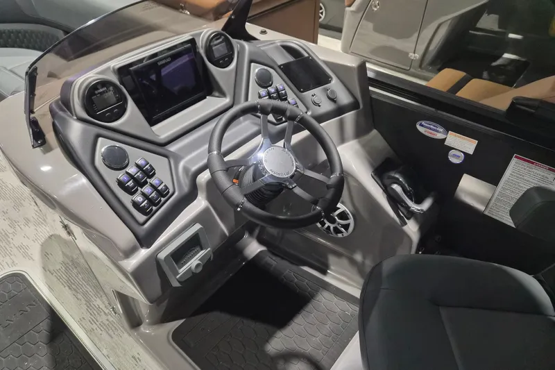 Slide: The Image of 2026 Sylvan L3 ULZ boat dashboard with steering wheel, controls, and display screens. - 23