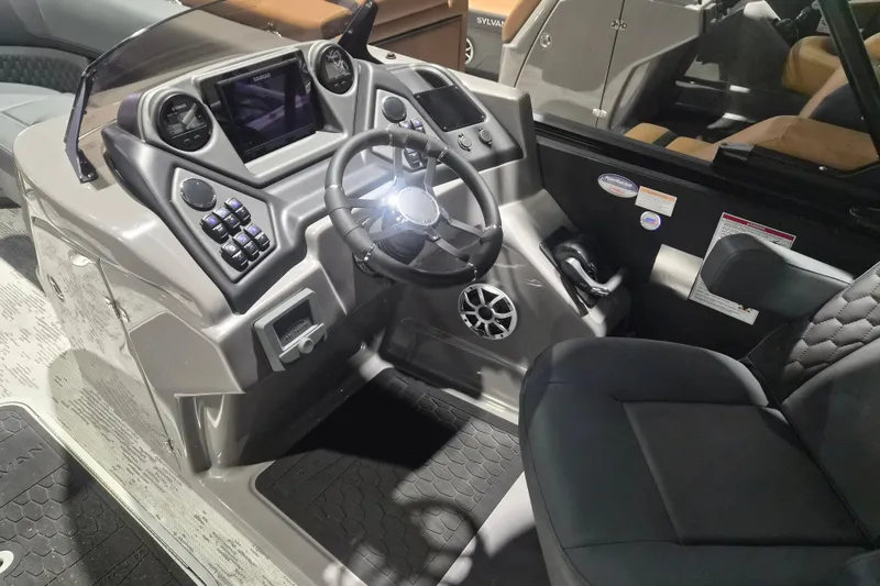 Slide: The Image of 2026 Sylvan L3 ULZ boat dashboard with steering wheel and control panel. - 11