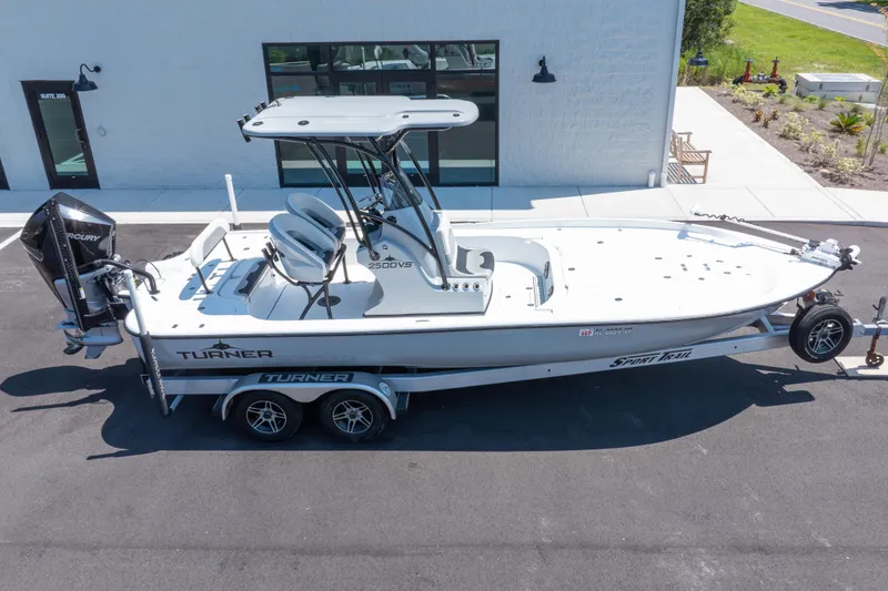 Slide: The Image of 2020 Turner Boatworks 2500 VS on trailer, parked outside a building. - 24
