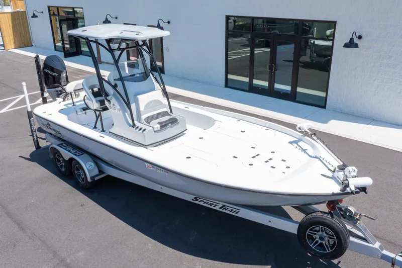 Slide: The Image of 2020 Turner Boatworks 2500 VS on trailer, parked outside a building. - 25