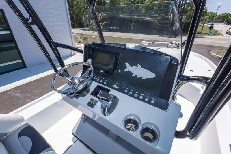 Slide: The Image of 2020 Turner Boatworks 2500 VS helm with steering wheel and navigation display. - 11