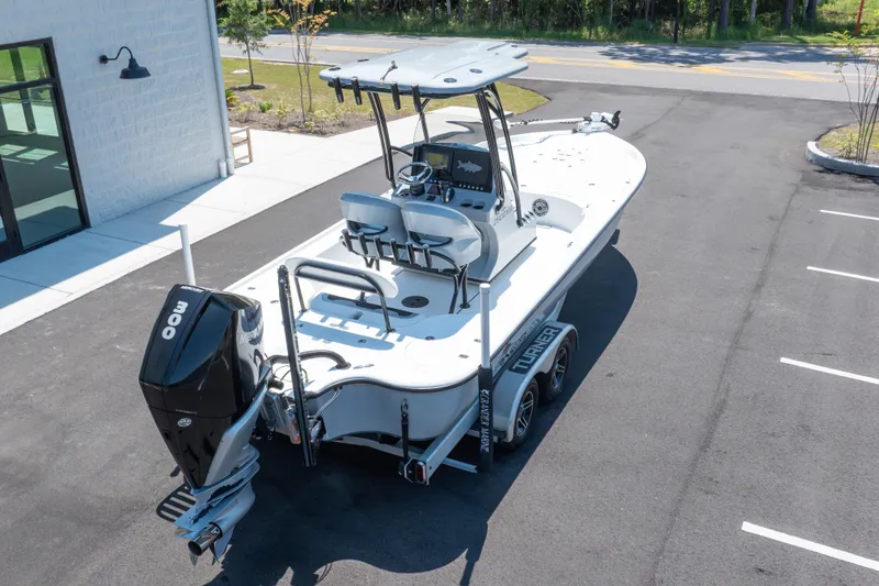 Slide: The Image of 2020 Turner Boatworks 2500 VS on trailer, parked outdoors, featuring a powerful outboard motor. - 23