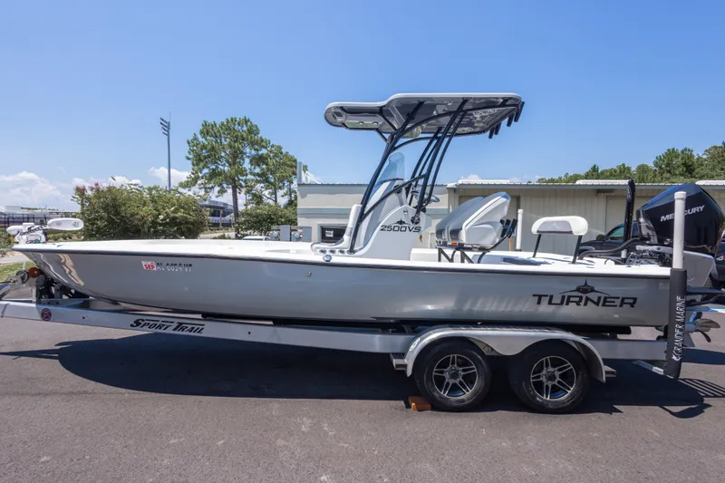 Slide: The Image of 2020 Turner Boatworks 2500 VS on trailer, featuring sleek design and Mercury engine. - 5