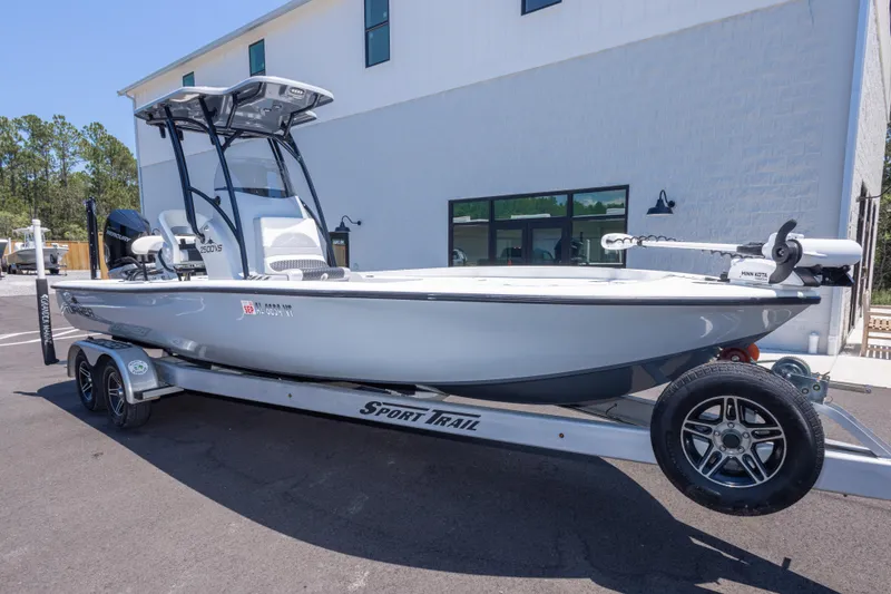 Slide: The Image of 2020 Turner Boatworks 2500 VS on trailer, parked outside a building. - 2