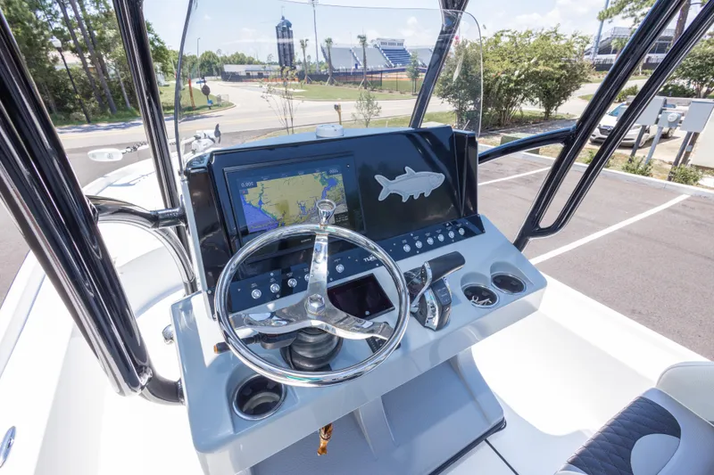 Slide: The Image of 2020 Turner Boatworks 2500 VS helm with navigation display and steering wheel. - 10