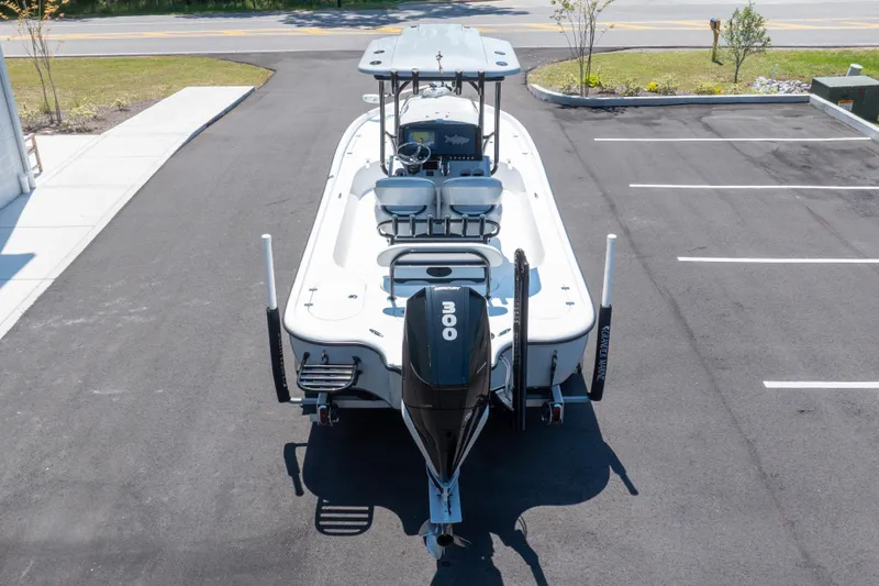 Slide: The Image of Turner Boatworks 2500 VS 2020 model with Mercury engine, parked on asphalt. - 22